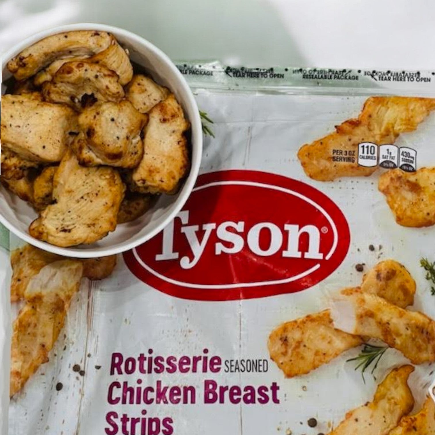 Enjoy a bowl topped with Tyson Rotisserie Seasoned Unbreaded Chicken Breast Strips from the 3-bag (48 oz each) set of tasty, high-protein chicken strips.