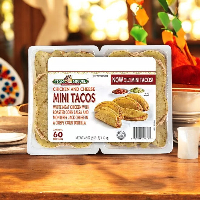 A package of Don Miquel Chicken and Cheese Mini Tacos, 60 count, 1 Case, sits on a table—showcasing the brand’s label and delicious mini tacos in a plastic container, ideal for fans of Mexican-inspired favorites.