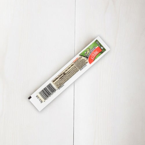 A slender, cardboard package of Splina Natural Soap rests elegantly on a white wood surface, evoking the sleek design of Frigo® Cheese Heads® Original Mozzarella String Cheese Snacks packaging.