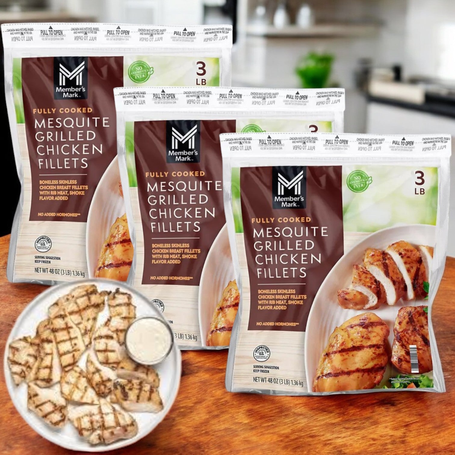Enjoy quick, fully cooked meals with three 3 lb packages of Member's Mark Mesquite Grilled Chicken Breasts. In a cozy kitchen setting, savor lean protein with sliced grilled chicken accompanied by a small cup of dip in the foreground.
