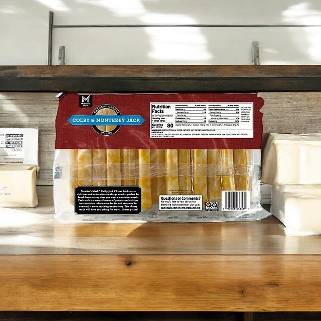 A 36-count package of Member's Mark Colby and Monterey Jack Cheese Sticks is showcased on a wooden shelf in bright lighting, making it an ideal snack.