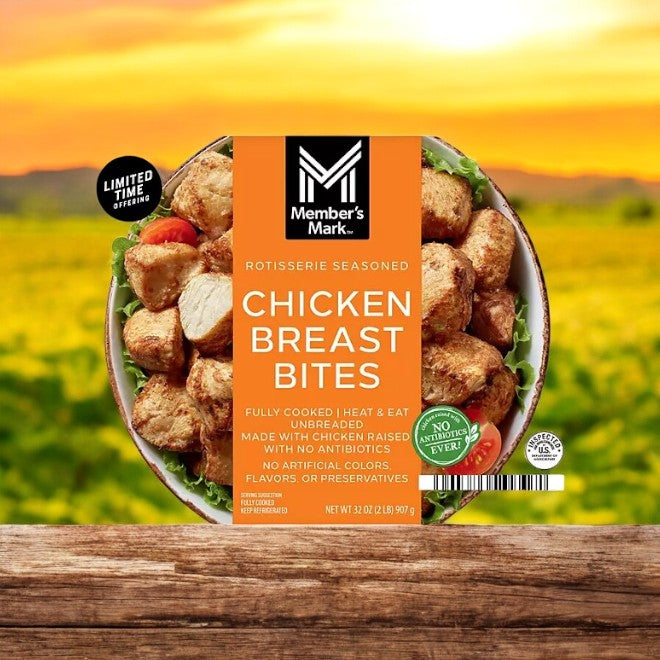 The Member's Mark Rotisserie Chicken Bites, packaged in a 2 lbs case, sits on a rustic wooden table with a field in the background, highlighting the convenience of pre-cooked bites perfect for any meal.