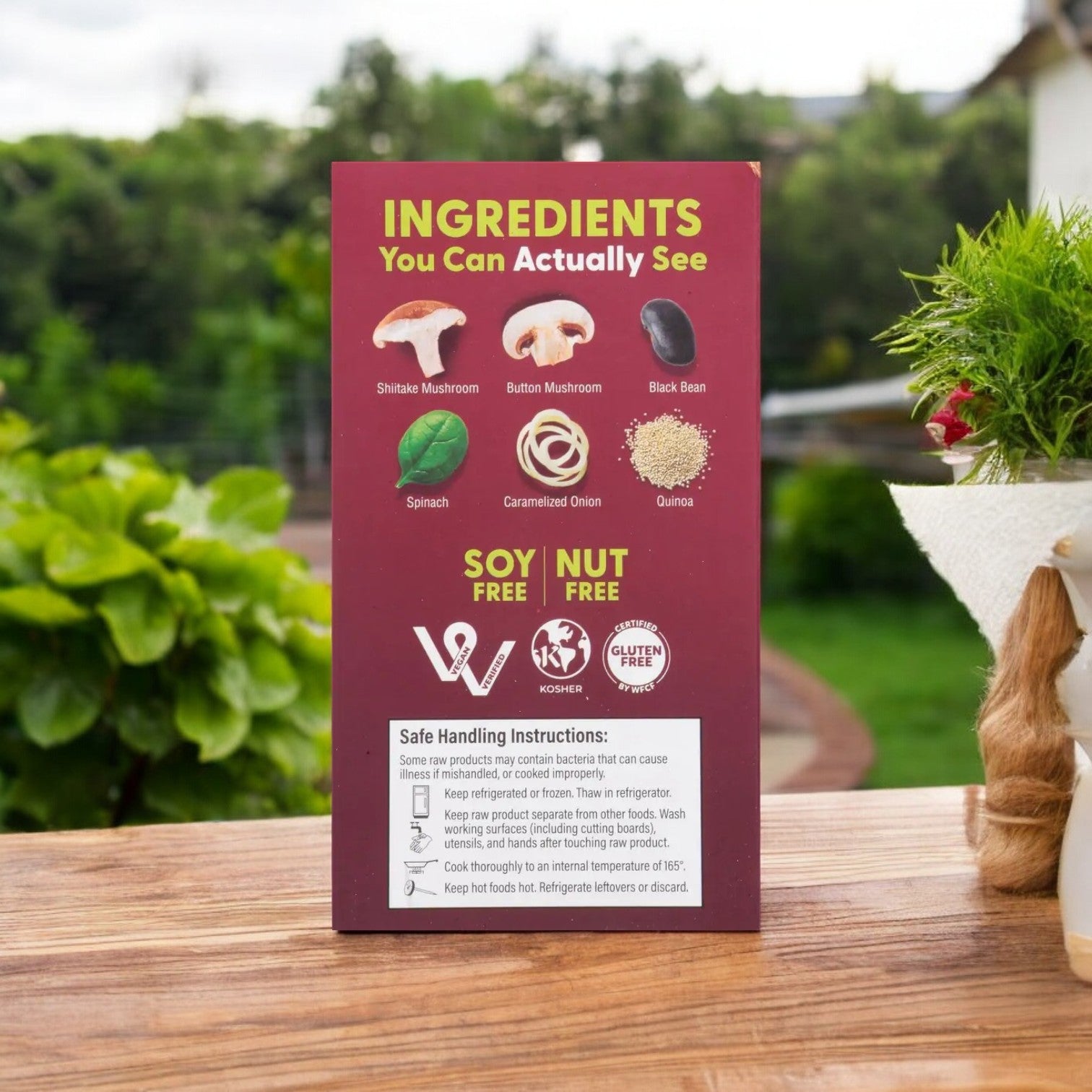 A burgundy package by Actual Veggies displays the Actual Veggies Mushroom Quinoa Veggie Burger, made with mushrooms, black beans, spinach, onions, and quinoa. The soy-free, nut-free, kosher, and gluten-free plant-based burger is packed with healthy protein.