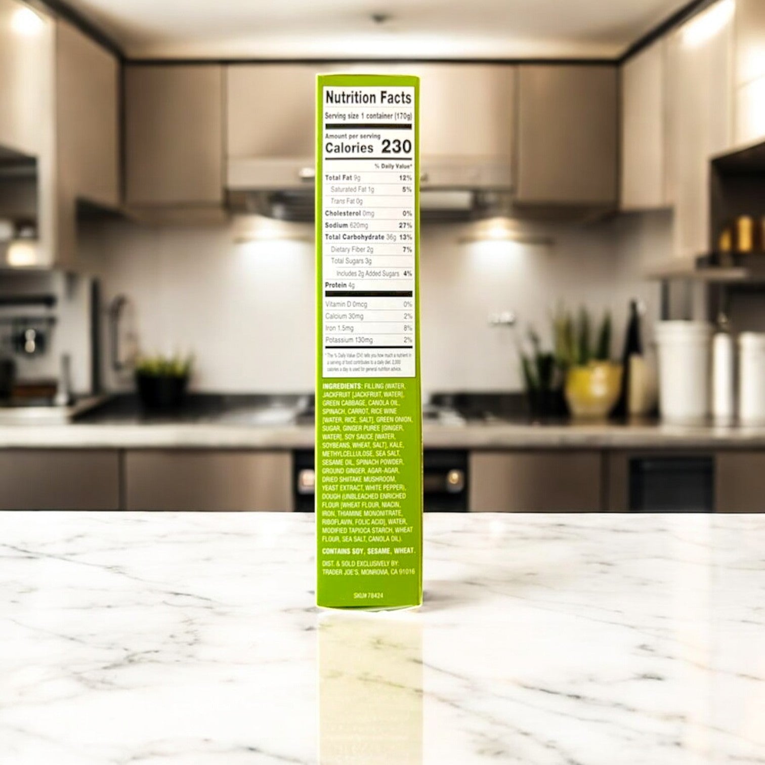 An Easy Lunches Steamed Vegetable Soup Dumplings box sits on a marble kitchen counter beside plant-based ingredients. Beige cabinets and stainless steel appliances in the background suggest adaptability from breakfast staples to Asian cuisine wonders.