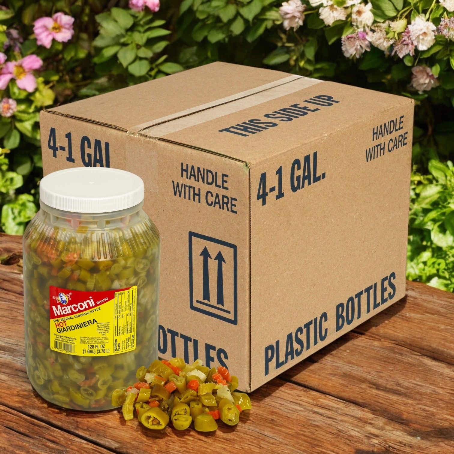 A jar of Marconi Giardiniera Hot, 4/1 Gallon Jars from Marconi Foods, sits beside a box labeled "4-1 Gal" and "Plastic Bottles" on a wooden surface, with vibrant pickled vegetables spilling out invitingly in front.