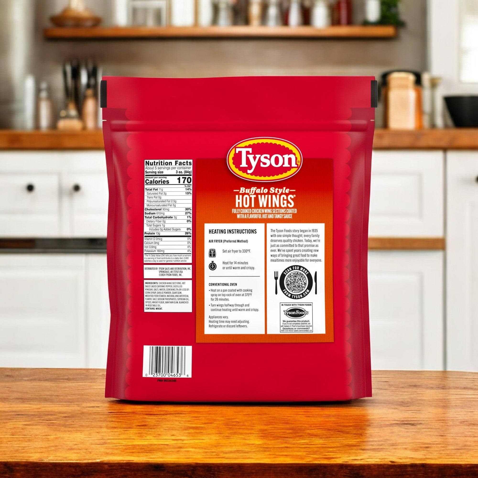 A Tyson Any’tizers Frozen Bone-In Buffalo Style Hot Wings Bag (1.37 lbs, 3 count) sits on a wooden kitchen counter surrounded by cabinets and utensils, offering a spicy kick to any meal.