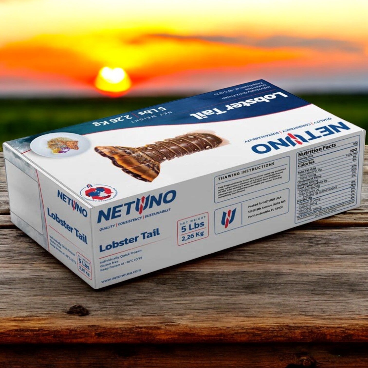 A 5 lb box of Netuno's Rock Lobster Tails, elegantly placed on a wooden surface against a blurred outdoor backdrop, promises to elevate your gourmet dining experience.