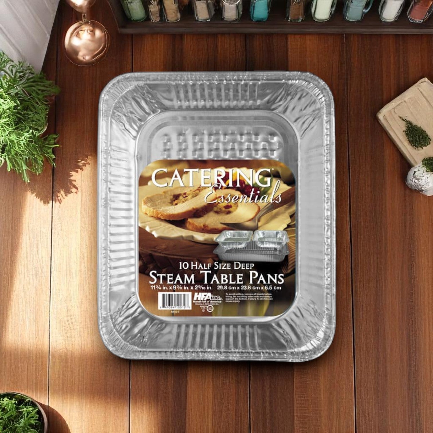 A 12-pack of Handi-Foil of America HFA Half-Size Deep Steam Table Pans rests on a wooden surface under natural light. These heavy-duty aluminum pans are perfect disposable options for catering, cooking, and food storage.