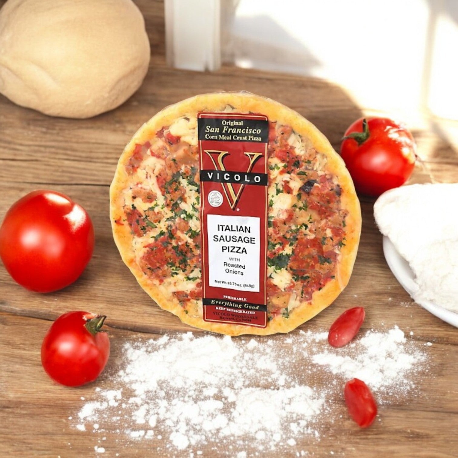 Vicolo Italian Sausage Pizza - 1 Count sits on a wooden surface, encircled by flour-touched tomatoes and dough, with a whiff of mozzarella.