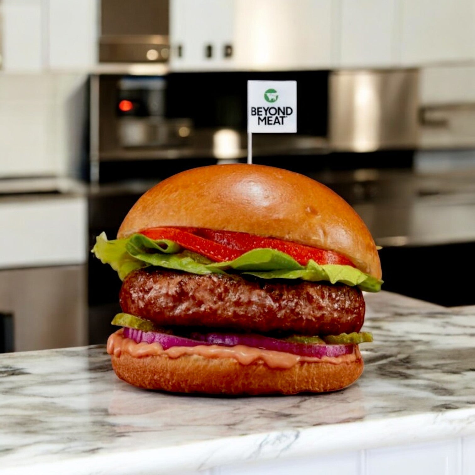 In a sleek, modern kitchen, a Beyond Meat Burger Vegetarian Beyond Patty (32/6 OZ) from Beyond Meat is garnished with fresh lettuce, tomato, and sauce on a marble countertop.