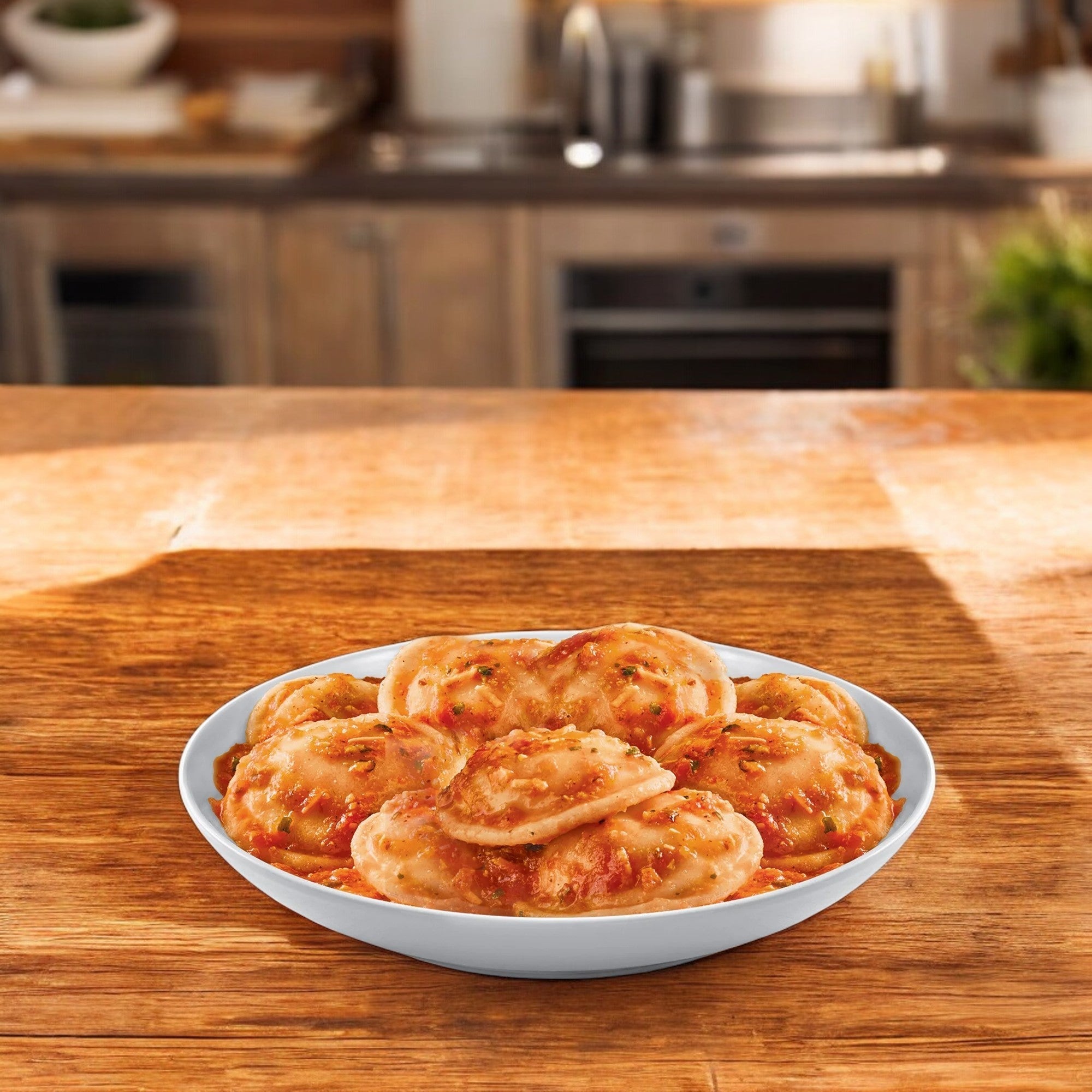 Udi's Gluten Free Three Cheese Ravioli, sitting on a wooden kitchen countertop with a blurred kitchen behind, offers a delightful twist on Italian comfort food. Enjoy all the flavors you love without the gluten.