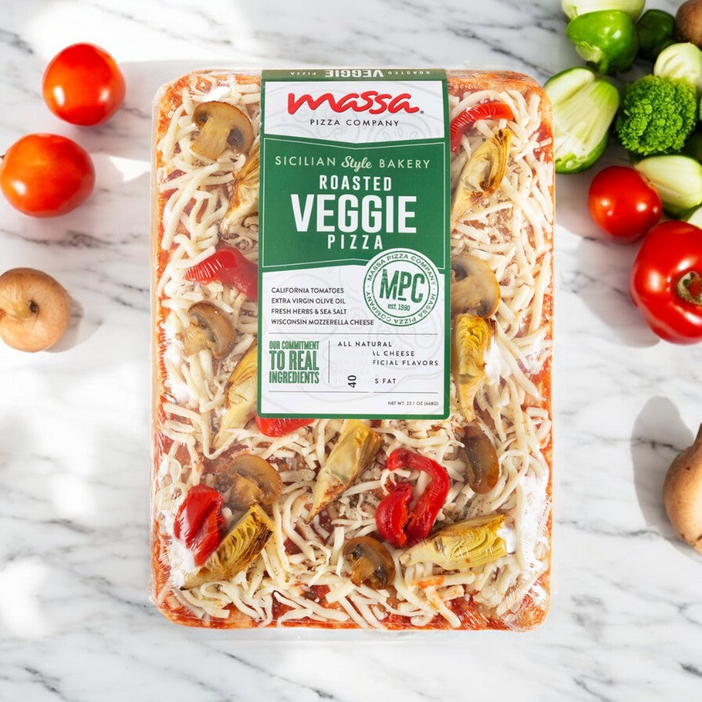 The Massa Pizza Co. Roasted Veggie Sicilian Bakery Pizza, 23.1 oz., by Massa Pizza is beautifully showcased with fresh vegetables on a marble surface, emphasizing its handcrafted dough.