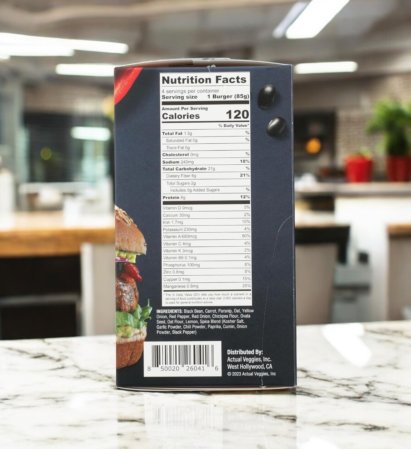 Nutrition facts for Actual Veggies Black Bean Burger-3 Count by Actual Veggies, displaying calories and ingredients, are on a kitchen counter with a blurred background.