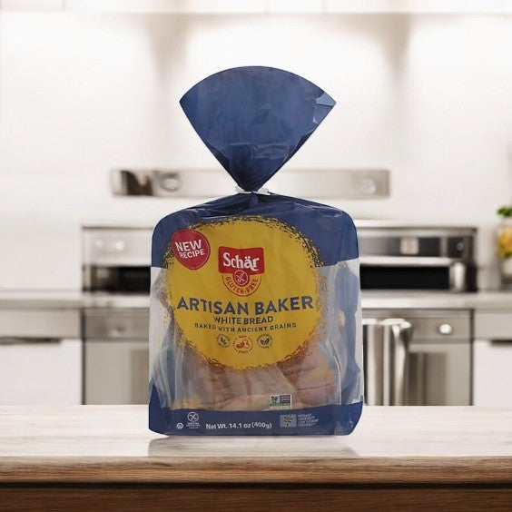 A loaf of Schar Bread Artisan Baker Gluten Free White rests on the kitchen countertop, providing a tasty gluten-free choice for those with dietary needs.