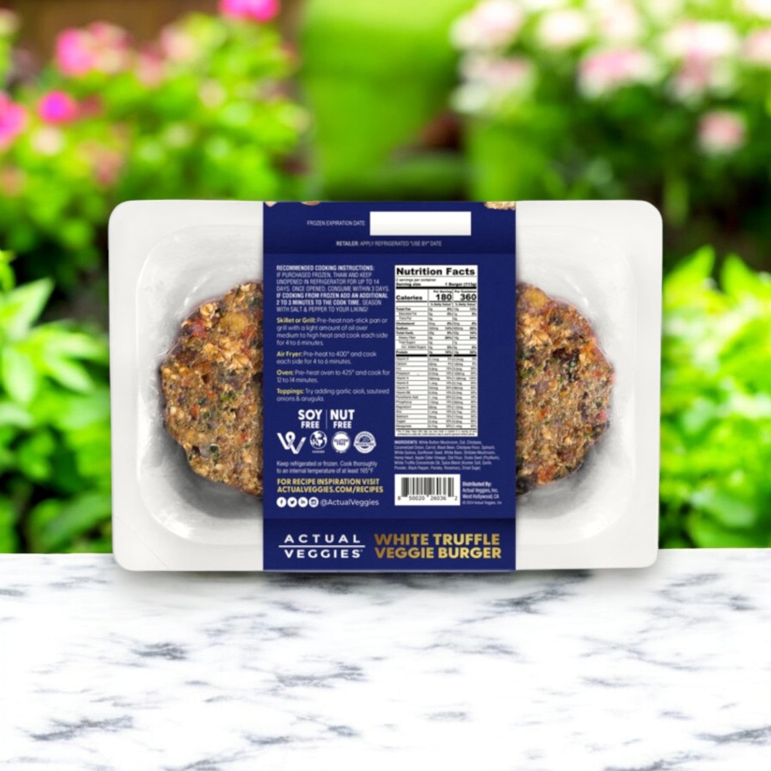 The Actual Veggies White Truffle Veggie Burger – 8 oz package features a plant-based patty against a blurred outdoor backdrop. The label provides nutritional facts, cooking instructions, and emphasizes its gluten-free quality.