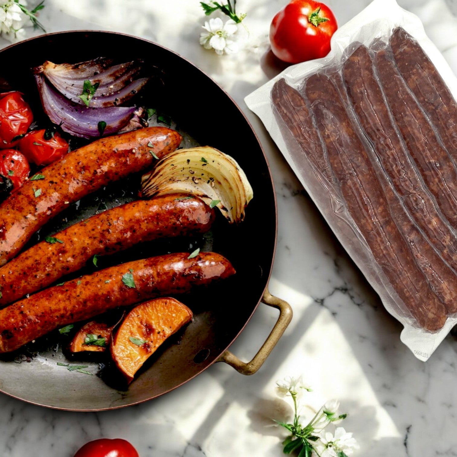 Grilled onions and tomatoes sizzle with Cajun flair next to vacuum-sealed Amylu Chicken Andouille Links from a 10 lb. box on a marble surface.