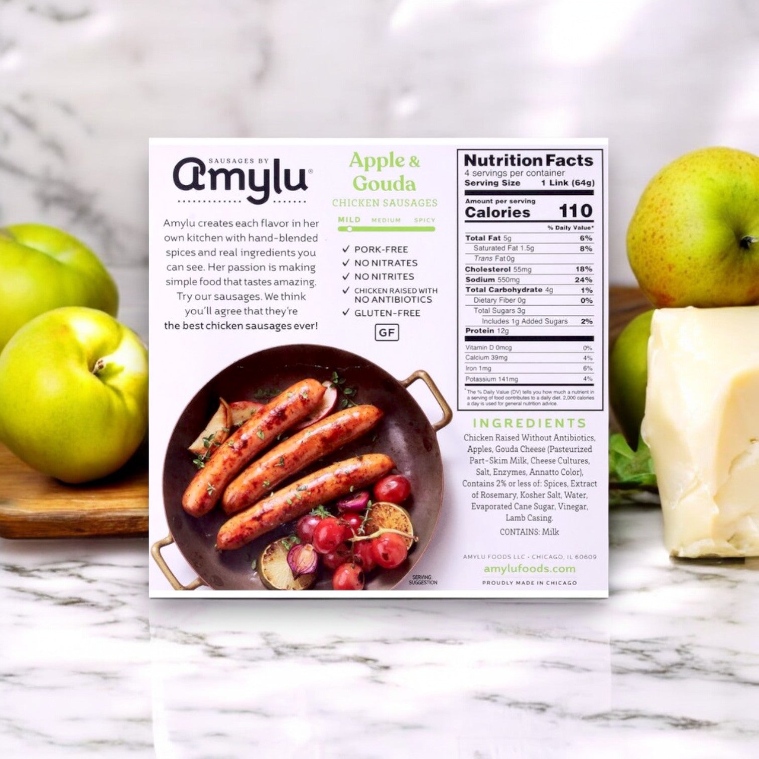 A box of Amylu Apple and Gouda Chicken Sausage- 3 Count offers a gourmet twist with apples and cheese. The packaging showcases nutritional facts and ingredients for these fully cooked sausages, perfect for quick, delightful meals.