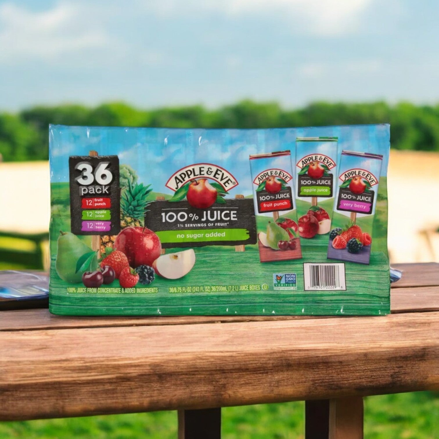 A 36-pack variety of Refreshing Apple & Eve Juice is displayed on wood amidst greenery. Enjoy real apple, berry, and fruit punch juices with Vitamin C and no added sugar.
