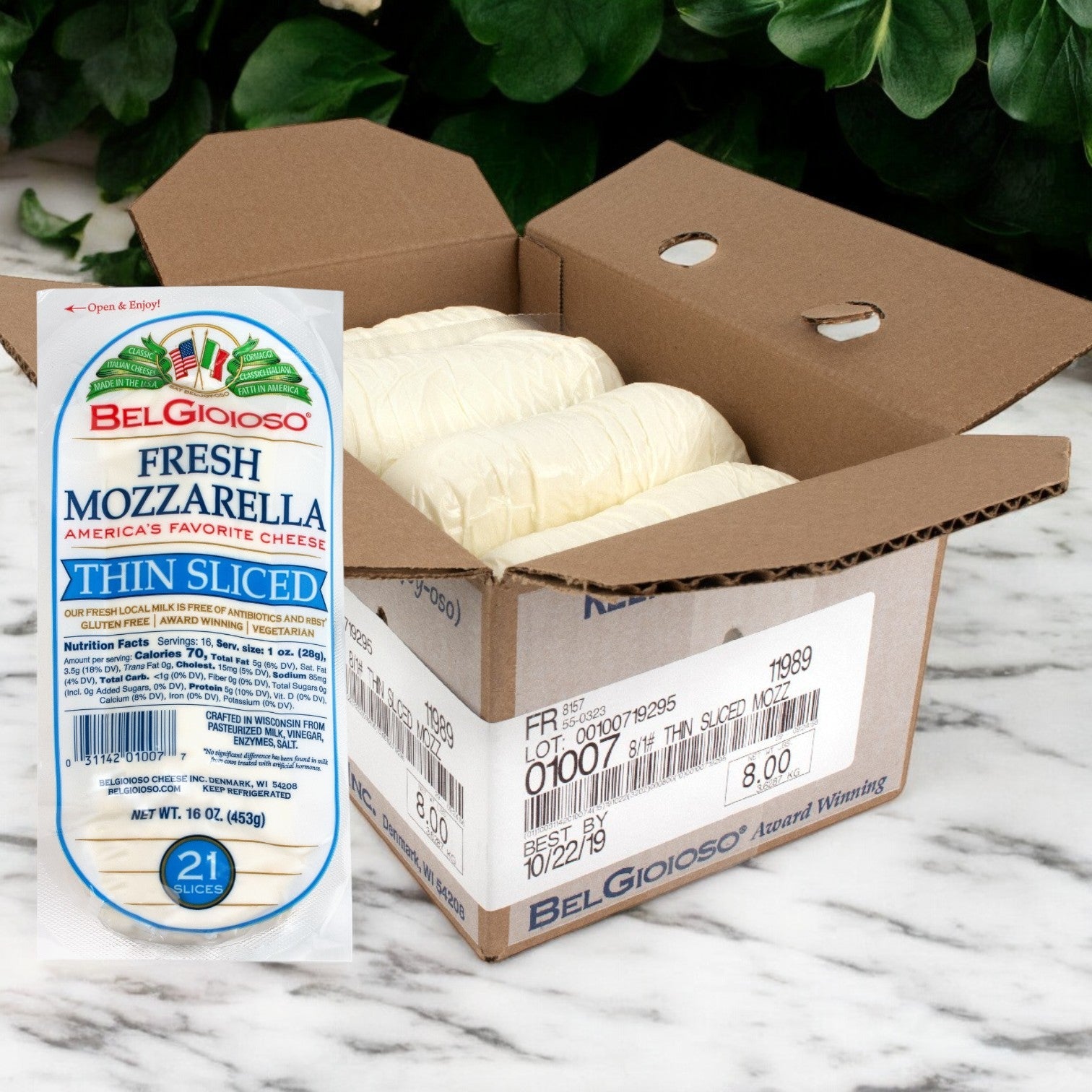 Open a cardboard box to reveal several vacuum-sealed packages of BelGioioso Fresh Mozzarella Cheese Thin Sliced – 8/1 LB on a marble surface.