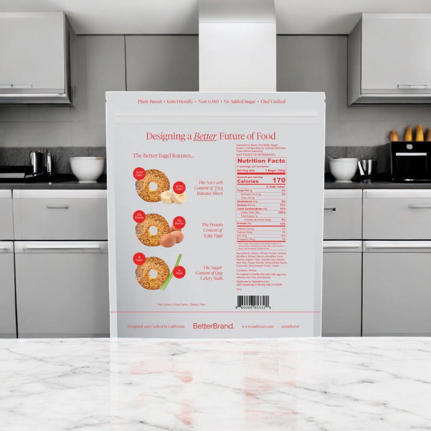 A BetterBrand Bagel Variety Pack, with 32 gluten-free bagels, sits on the marble countertop. The packaging displays appetizing images and highlights high protein content with nutrition facts—ideal for those wanting a healthy classic twist.