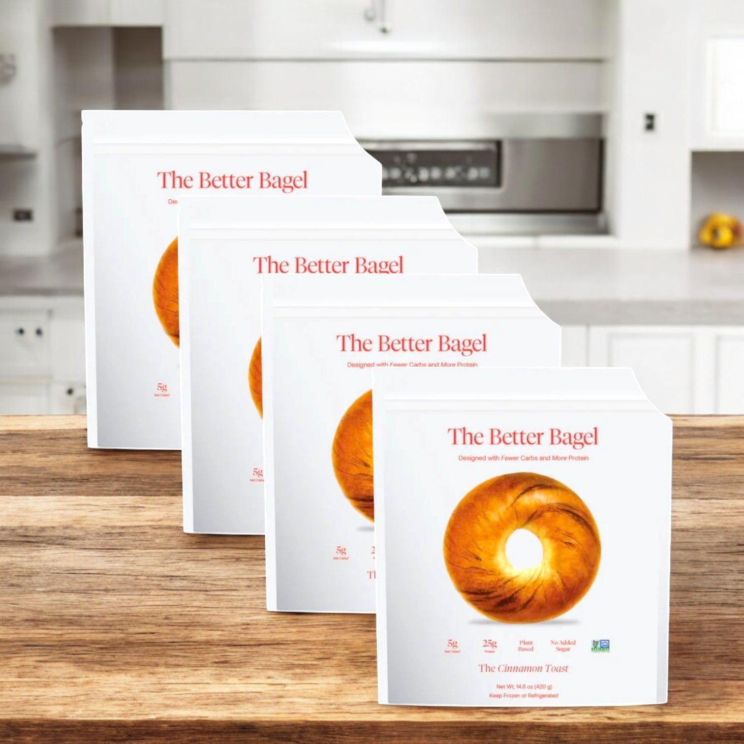 Displayed on a wooden kitchen surface are BetterBrand's Cinnamon Better Bagels—four bags totaling 16 bagels—an irresistible sweet start to your day, in stock and ready to ship.