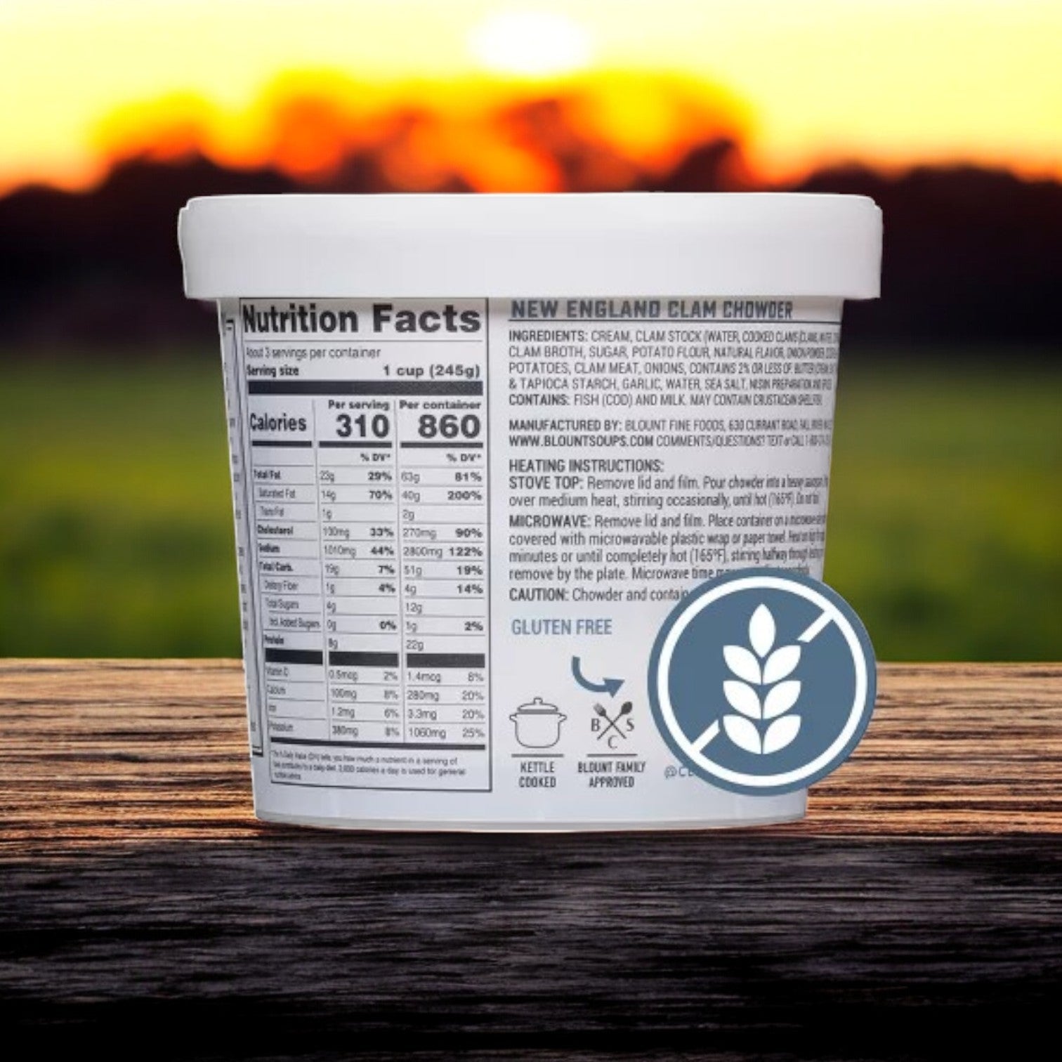 The Blount Fine Foods 24 oz. Clam Shack Gluten Free New England Clam Chowder Soup is crafted with premium ingredients, featuring nutritional facts and a gluten-free symbol against a blurred sunset field backdrop.