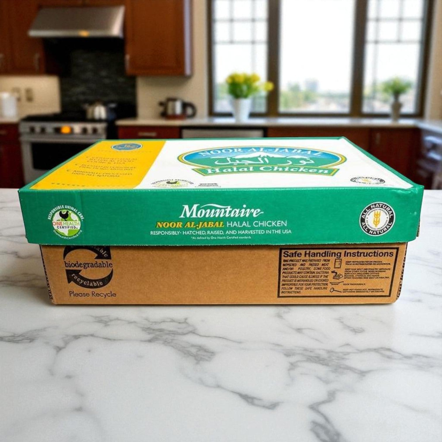 A 40 lb case of Restaurant Depot Boneless, Skinless Chicken Breasts, Halal sits on a marble countertop in a modern kitchen with appliances and a window in the background.