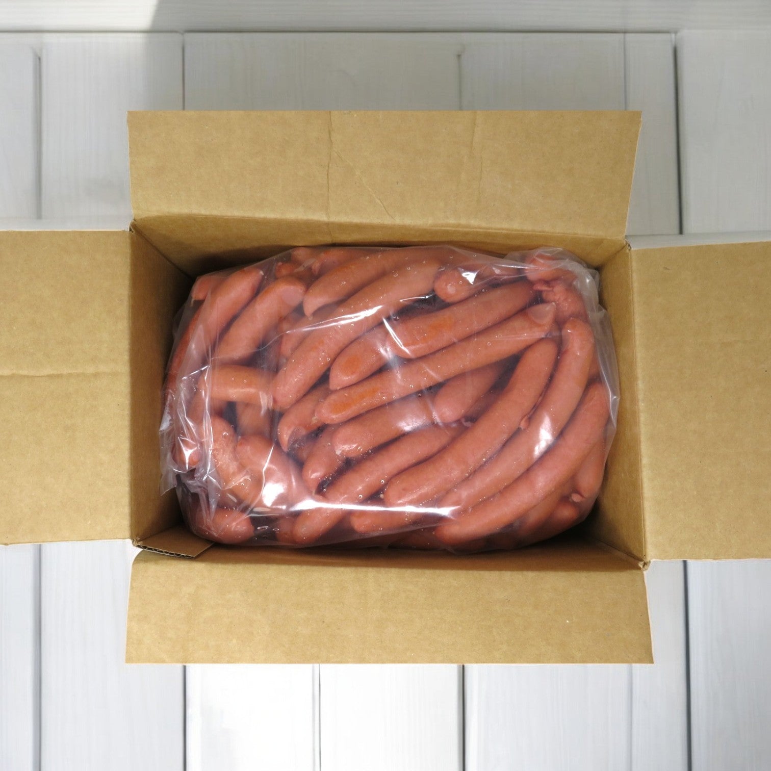 Vacuum-sealed, premium Vienna Beef hot dogs are displayed in an open cardboard box. Product: Vienna Frank All-Beef, 10 lbs. - 1 Case 8X1, totaling 80 hot dogs.