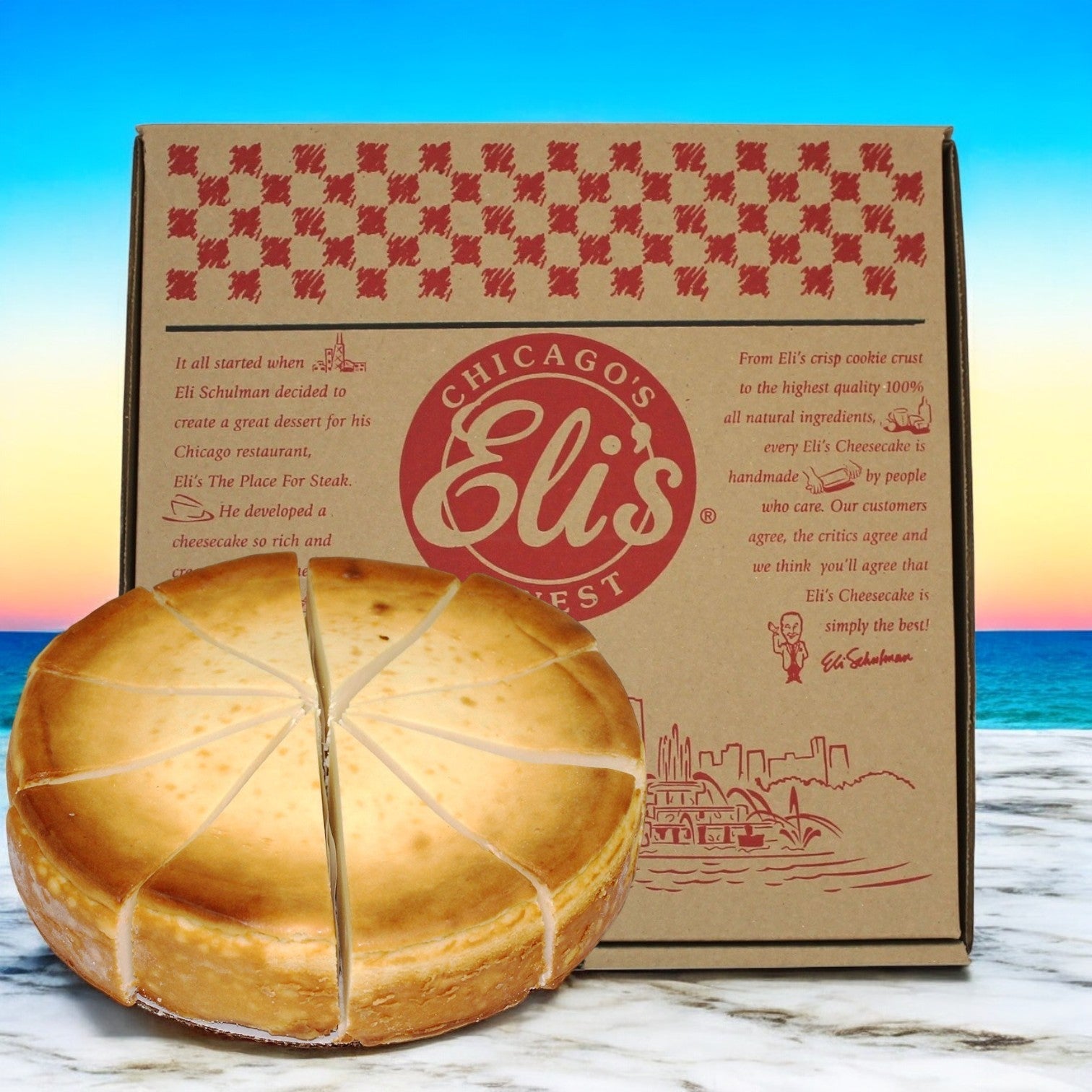 A classic Eli's Cheesecake, a 10" round plain cheesecake with 14 slices, sits elegantly in front of a Chicago-themed box, framed by a serene beach background.