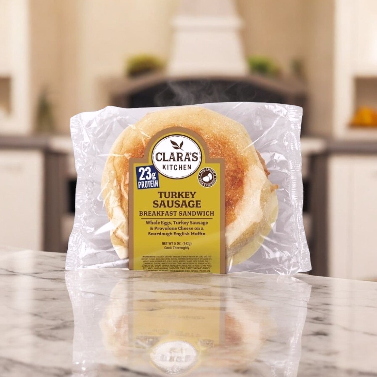 A Clara's Kitchen 5 oz. Individually Packaged Turkey Sausage Breakfast Sandwich rests on a marble countertop.