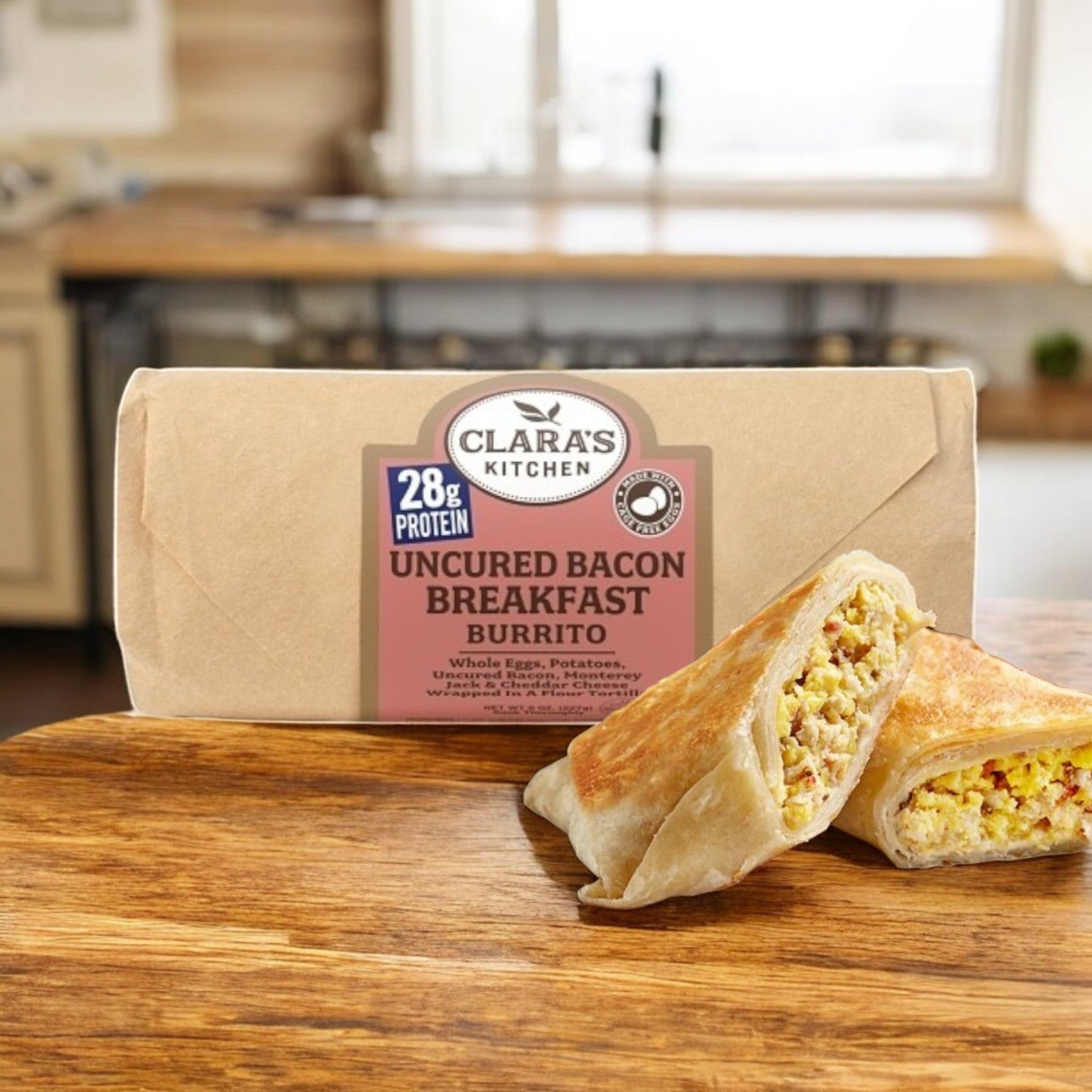 A Clara's Kitchen Individually Packaged Uncured Bacon Breakfast Burrito, 8 oz. is showcased on a wooden surface, displaying a halved burrito teeming with eggs, potatoes, and cheese.