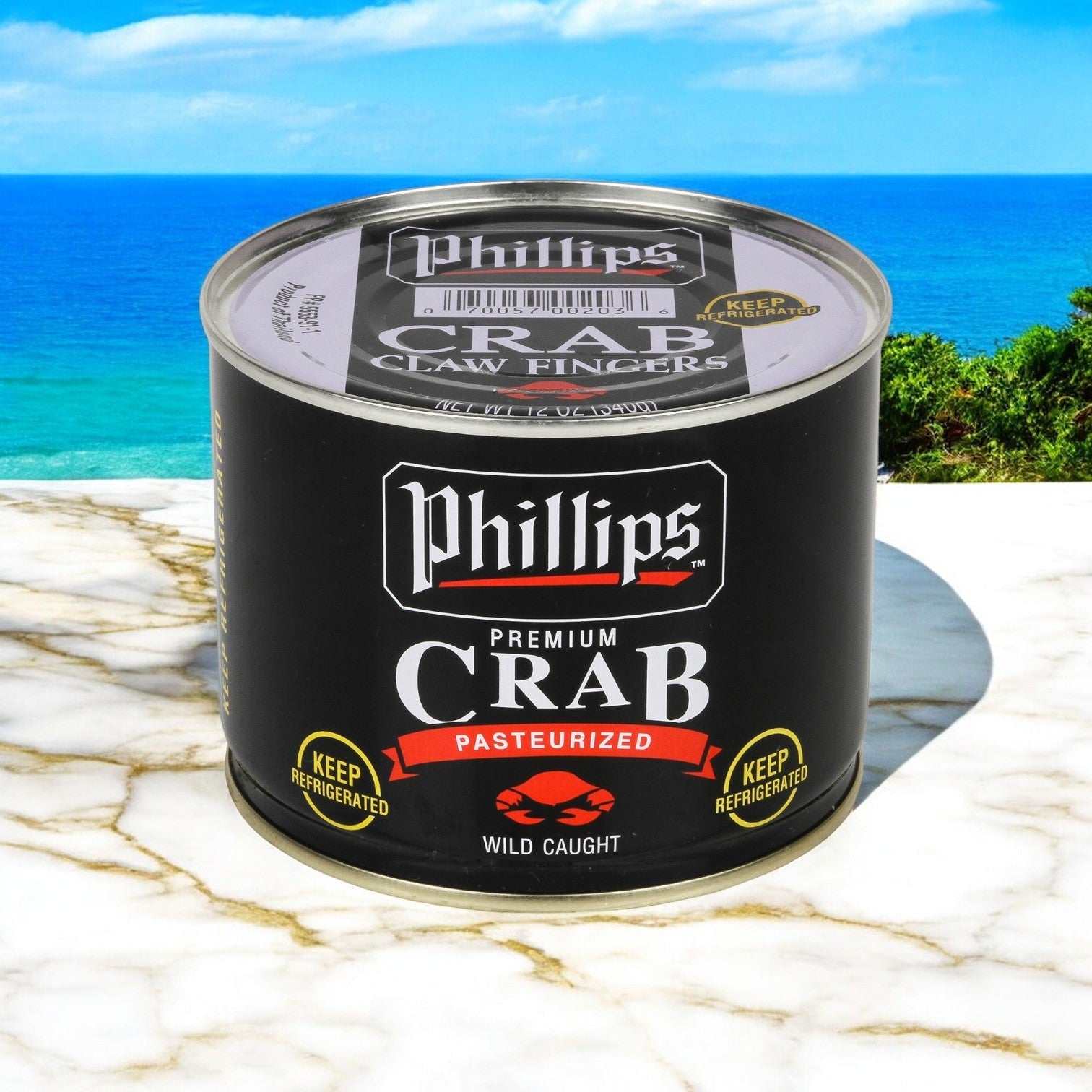A can of Phillip Foods Crab Claw Finger Pasteurized Asia, 12 oz. - 1 Case, 6 Cans by Phillips Foods, featuring sustainably sourced and pasteurized crab meat, rests on a marble surface with an ocean view behind it.