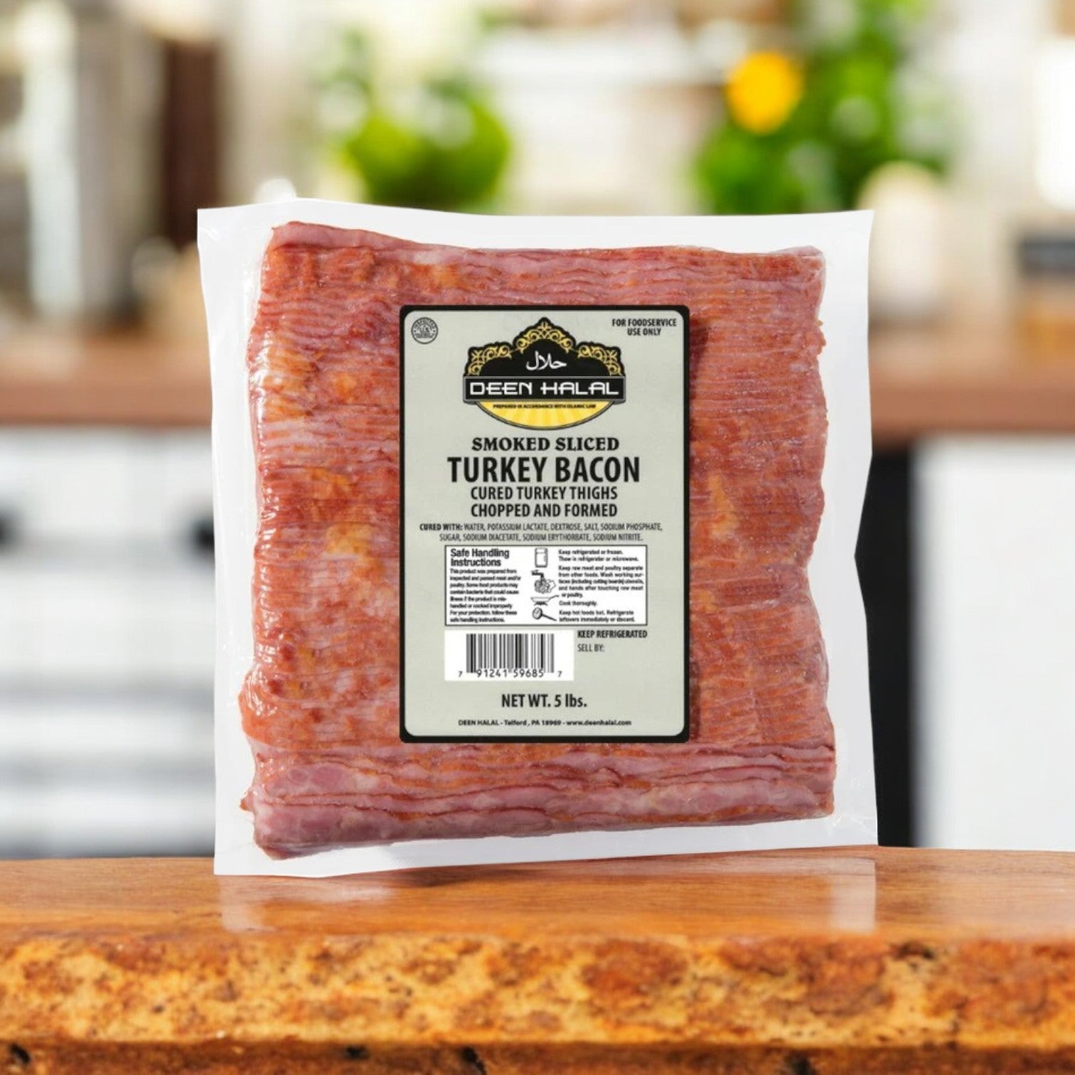 A pack of Deen Halal Turkey Bacon, Sliced, 5 lbs, featuring premium turkey meat rests on a kitchen countertop with a blurred background for focus.