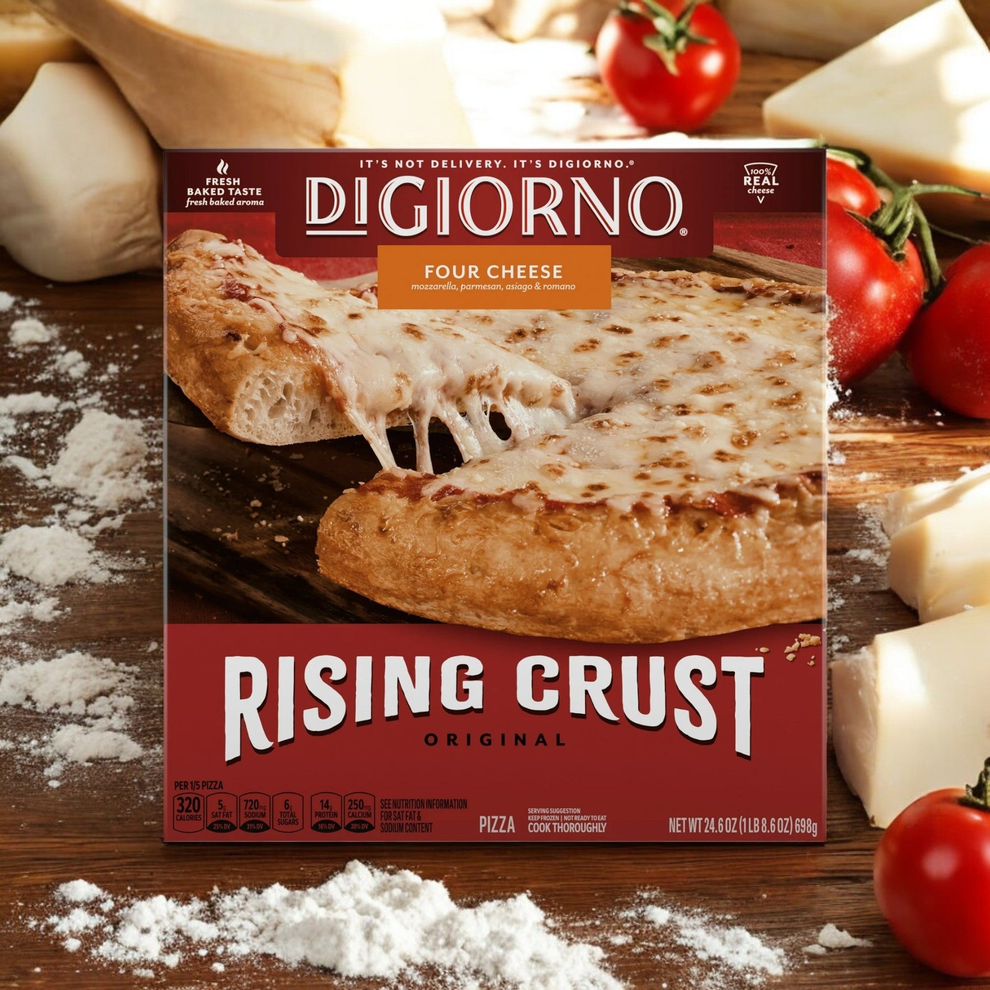 A DiGiorno Rising Crust Four Cheese Frozen Pizza – 24.6 oz box, branded by DiGiorno and featuring 100% real cheese, rests on a rustic wooden surface surrounded by fresh tomatoes and flour.