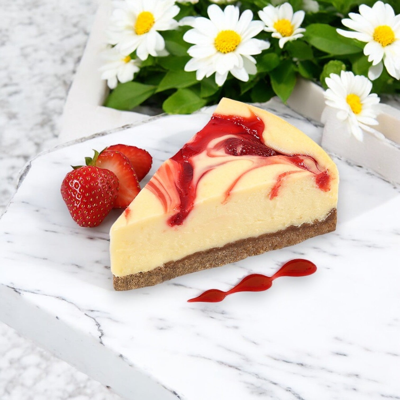 A slice of strawberry swirl cheesecake from Eli's 9" Classic Cheesecake Sampler is elegantly presented on marble with fresh strawberries and white flowers, capturing the essence of Eli's Cheesecake.