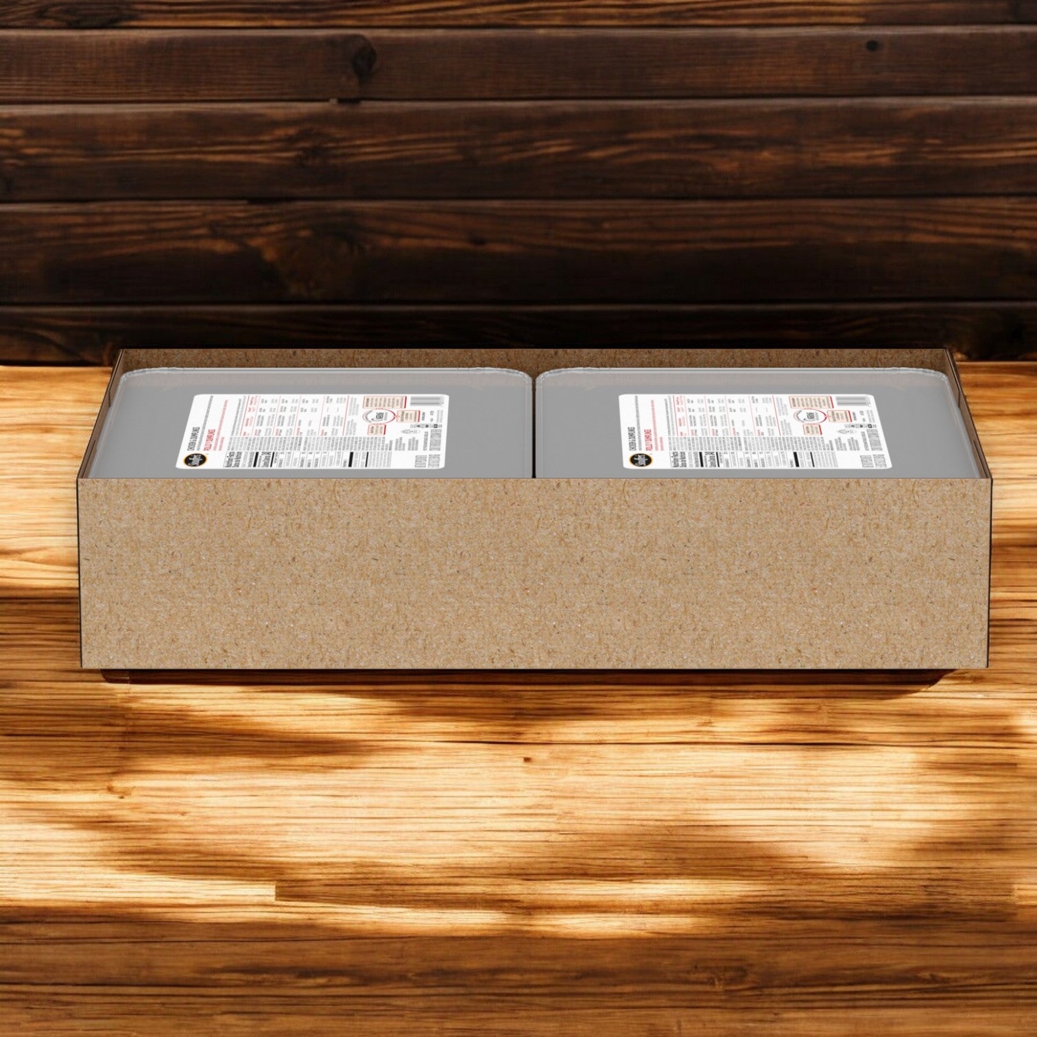 A cardboard box contains two gray cans labeled with detailed product information, resting on a wooden surface against a wood-paneled background, offering the comforting taste of savory chicken and fluffy dumplings. Enjoy Stouffer's Entree Chicken And Dumpling in every bite!.