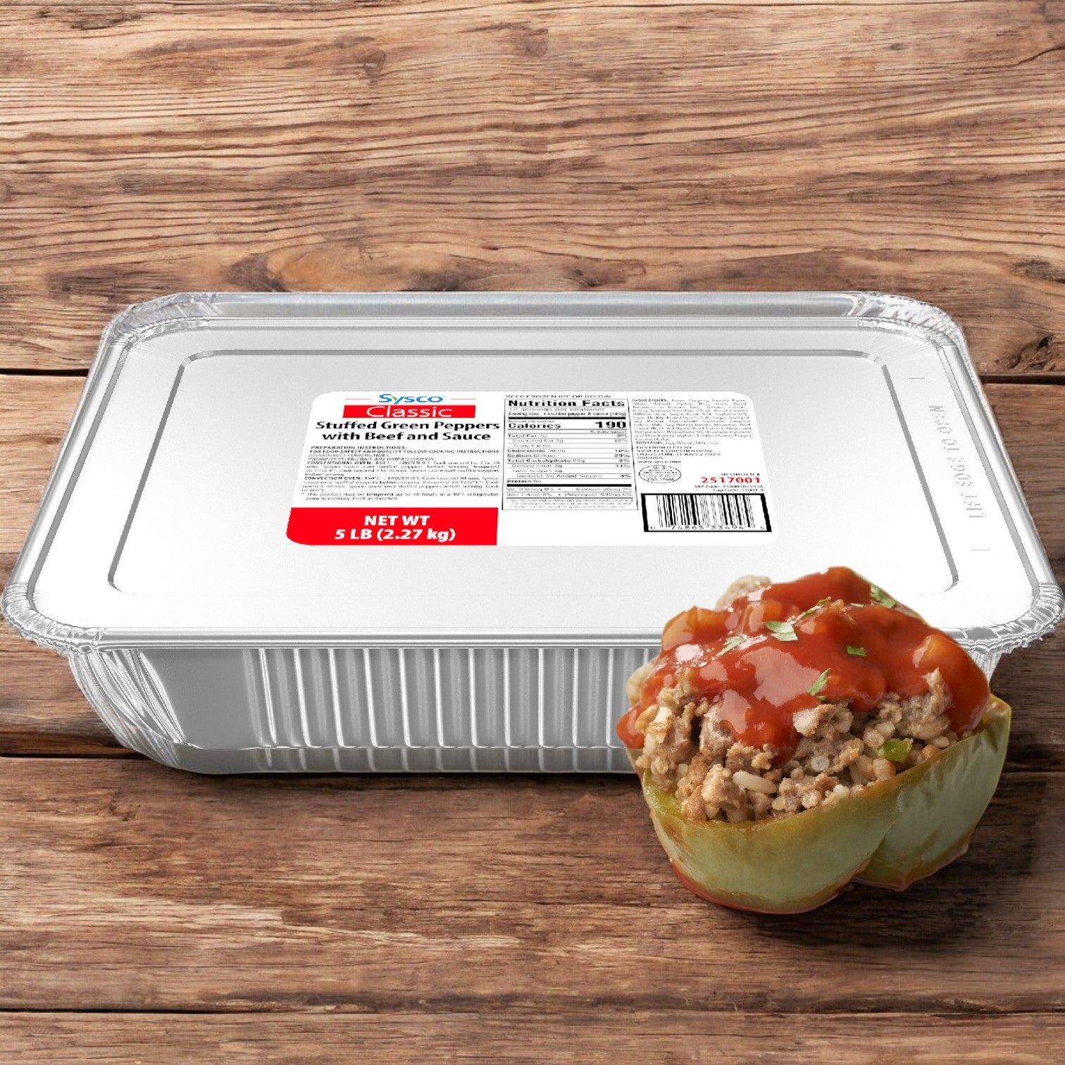 A Sysco Classic Entree Pepper Stuffed Green Prepared tray from a 5 lbs. case sits on wood. The flavorful beef filling in the green pepper topped with sauce invites you to enjoy each bite.