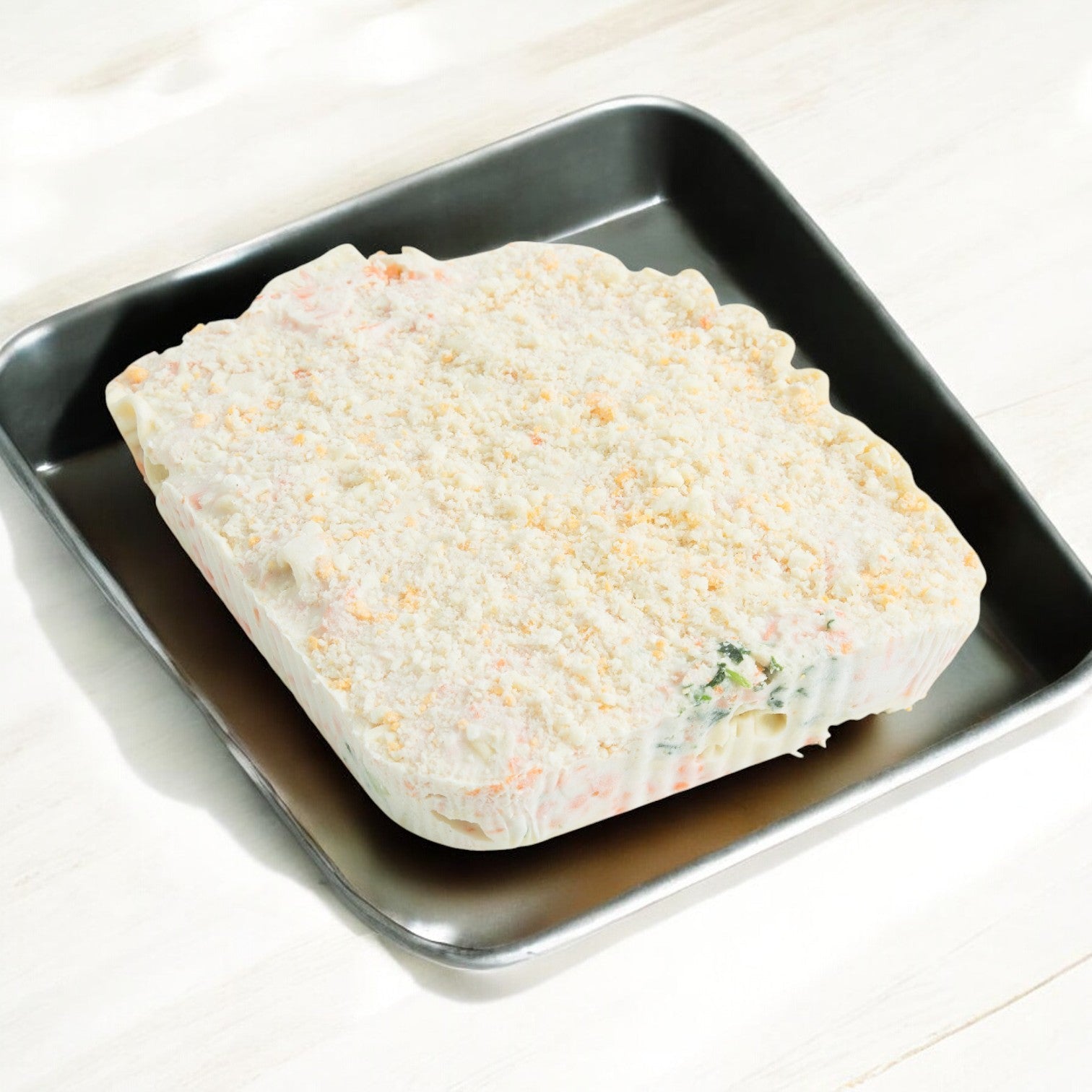 A convenient meal solution, Sysco's Gilardi Calzone Meat Combo offers a rectangular breaded frozen block in a square metal baking pan, promising a hearty meat-filled calzone for those craving it. Each case includes 60 calzones at 4.9 oz each.