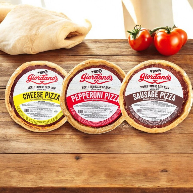 Three Giordano's Deep Dish Pizzas: cheese, pepperoni, and sausage varieties grace a wooden surface. Their ingredients and two tomatoes in the background highlight the combo pack, paying homage to Giordano's pizza legacy.