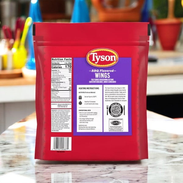 The Tyson Any'tizers BBQ Flavored Chicken Wings, 1.37 lb, 3 Count package is on a kitchen counter, showing nutrition facts and heating instructions on the back. These crispy bone-in chicken wings are covered in smoky BBQ sauce for a perfect savory bite every time.