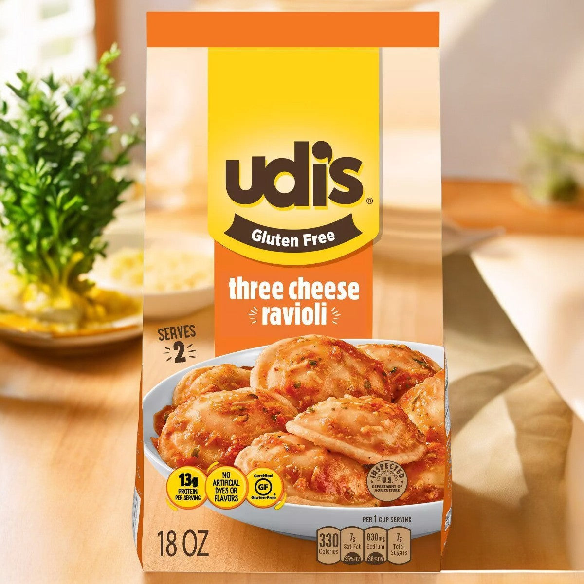 Udi's Gluten Free Three Cheese Ravioli- 1 Count sits on a wooden table, embodying Italian comfort food with its packaging that features nutritional info and serving size for a health-conscious treat.
