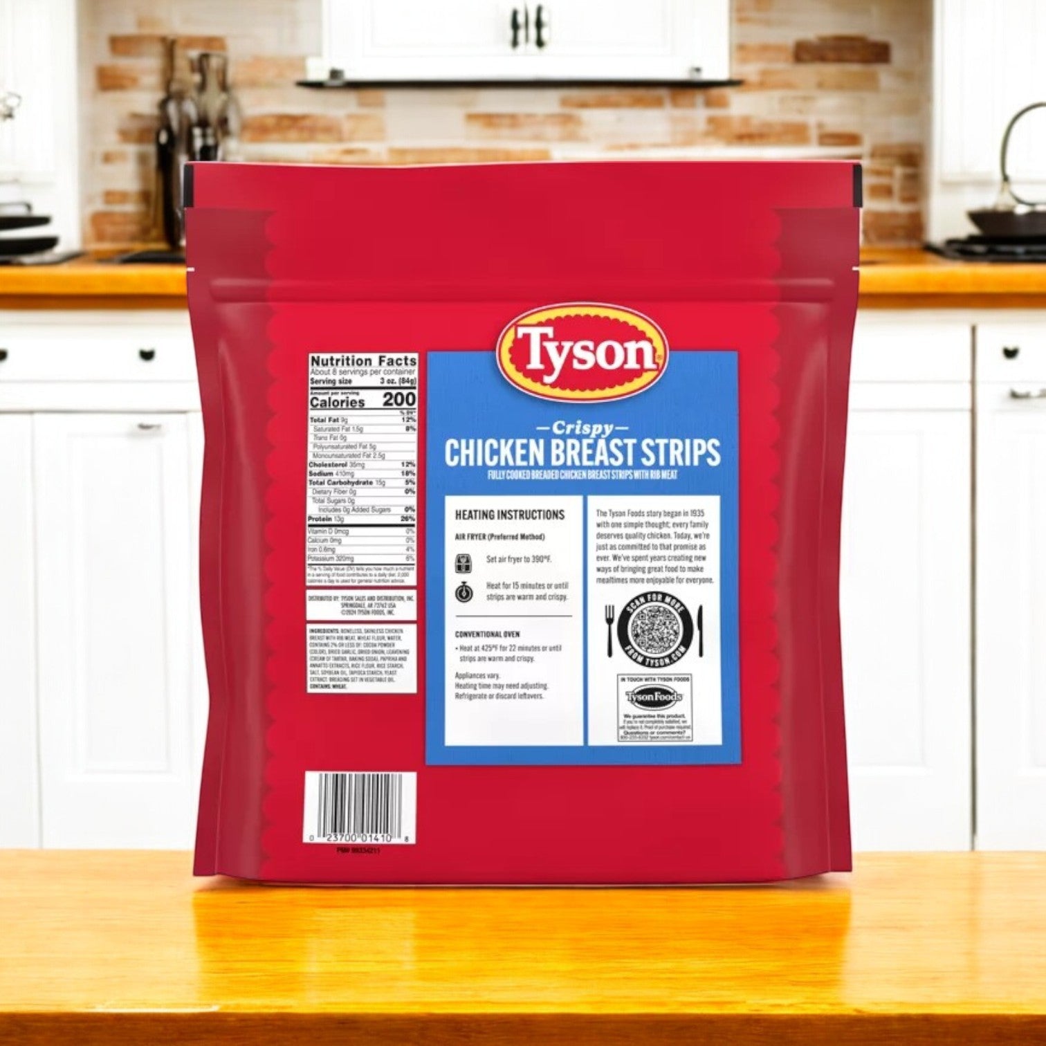 A 25 oz bag of Tyson All Natural Crispy Chicken Strips is on a kitchen counter, showcasing its red package with nutritional details and heating instructions, emphasizing the use of 100% all-natural chicken.