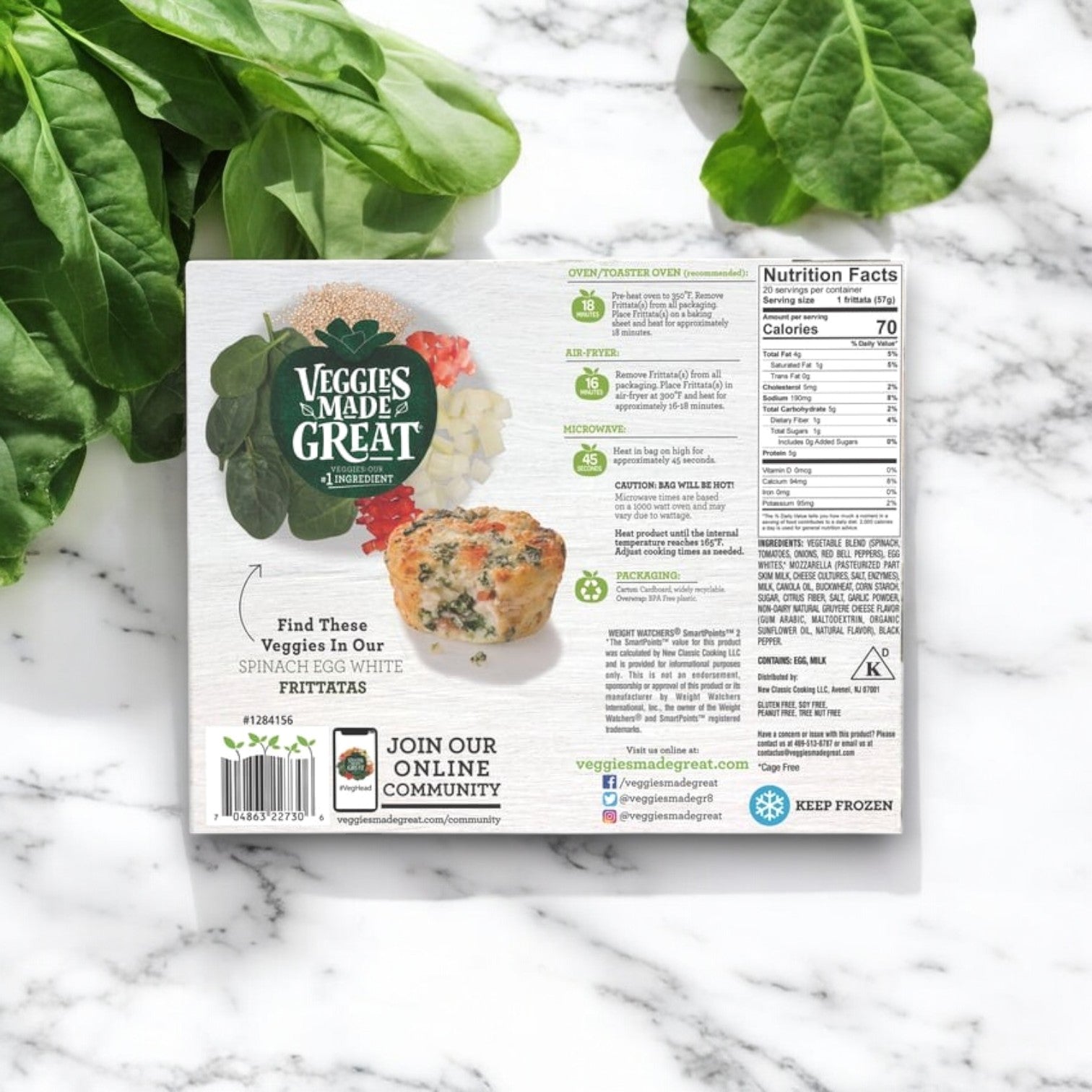 On a marble surface sits a box of Veggies Made Great Garden Lites Vegetarian Spinach & Egg White Frittatas (20-Count), featuring images of spinach, onion, and red pepper. It’s an excellent low-calorie breakfast option with nutritional facts and social media links for inspiration.