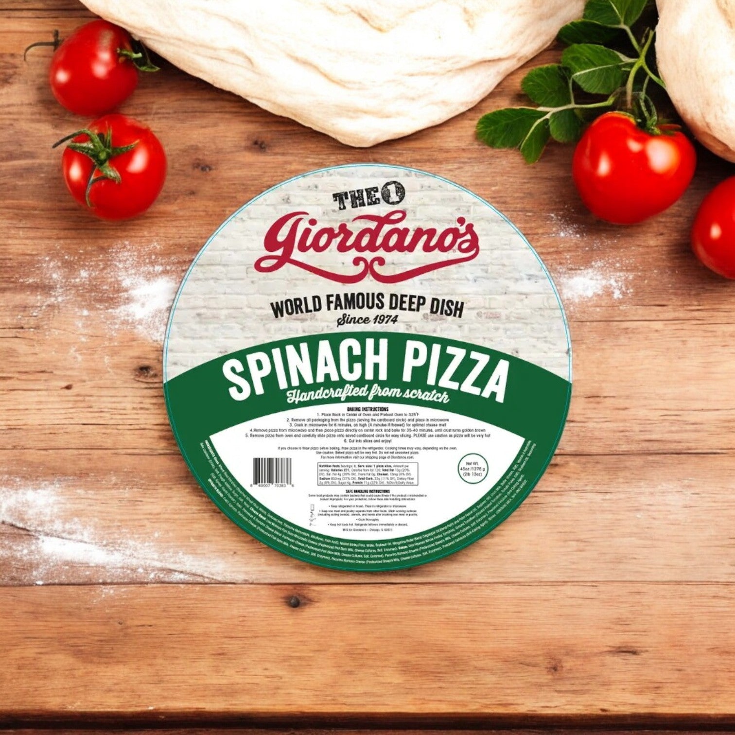 Giordano's Frozen Deep Dish Stuffed - Spinach Pizza (10" - 3 Packs) rests on a wooden surface, encircled by ripe tomatoes and fresh spinach leaves, capturing the spirit of Spinach Deep Dish Pizza.