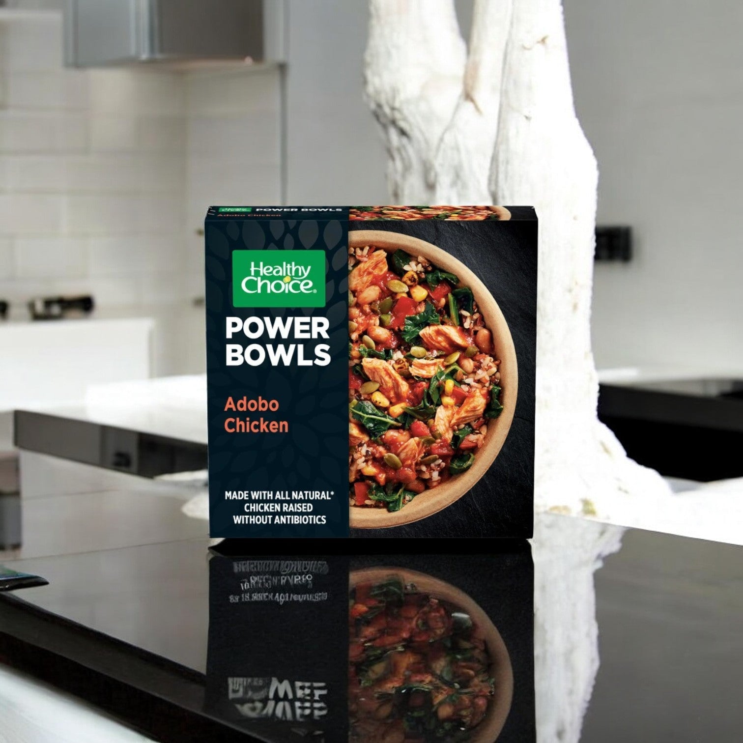 A box from the "Healthy Choice Power Bowl Variety Pack" sits on a sleek kitchen counter, showcasing the convenience of preparing nutritious microwaveable meals from Healthy Choice.