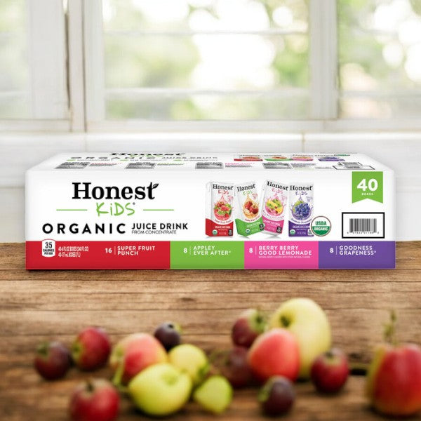 Box of Easy Lunches Honest Organic Kids Juice Drink with 40 pouches, a healthy drink variety pack featuring flavors: Super Fruit Punch, Appley Ever After, Berry Berry Good Lemonade, and Goodness Grapeness. Mixed fruit is displayed in the foreground.