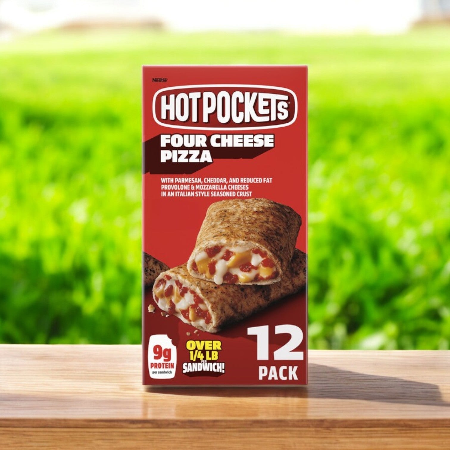 Image of Hot Pockets Four Cheese Pizza – 12 Count box on wood with a green blur backdrop. Ideal for a quick snack, featuring 9g of protein and over 1/4 lb per sandwich.