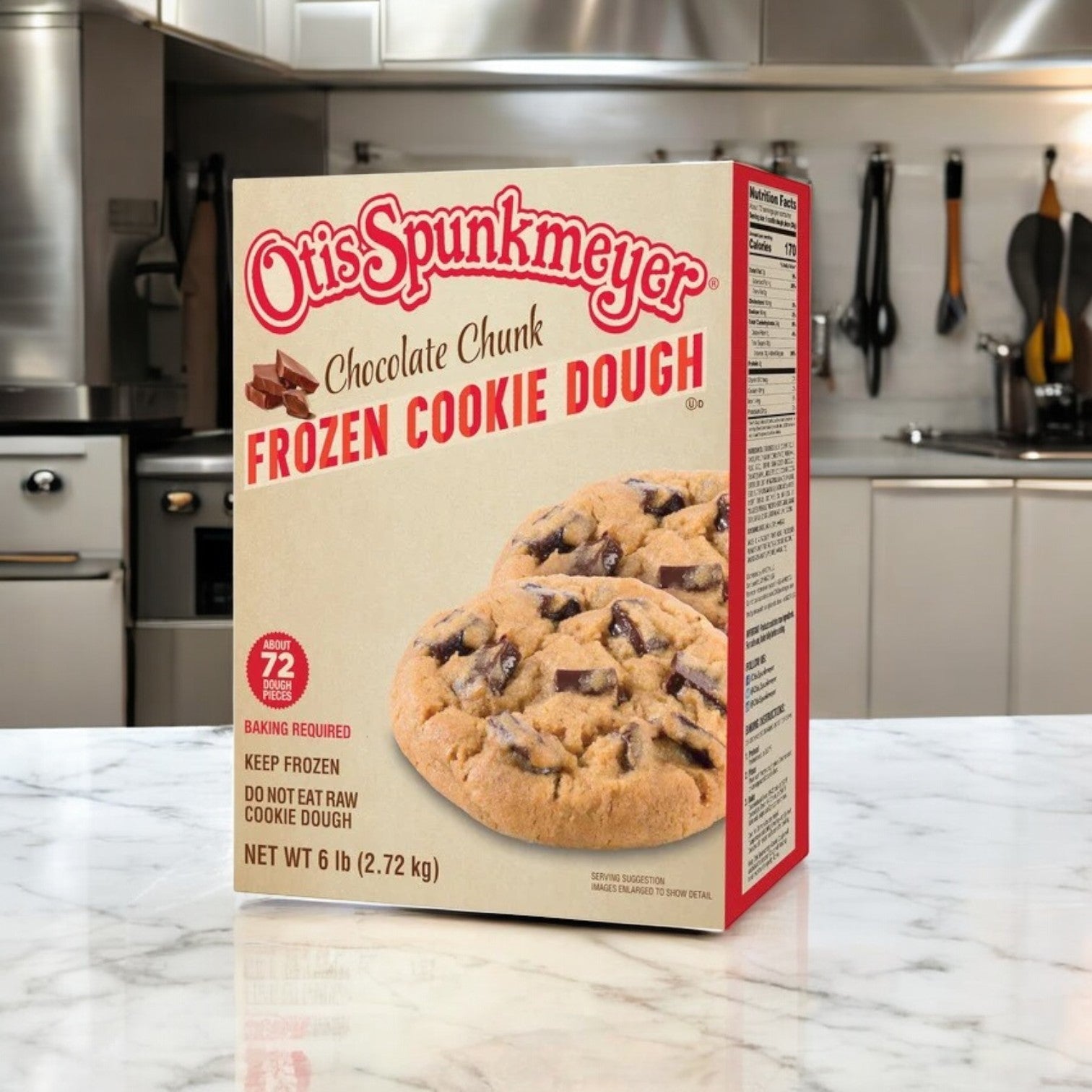 An inviting bulk package of Otis Spunkmeyer Chocolate Chunk Cookie Dough (3 Count, 18 lbs Total) rests on the marble countertop of a sleek, modern kitchen.