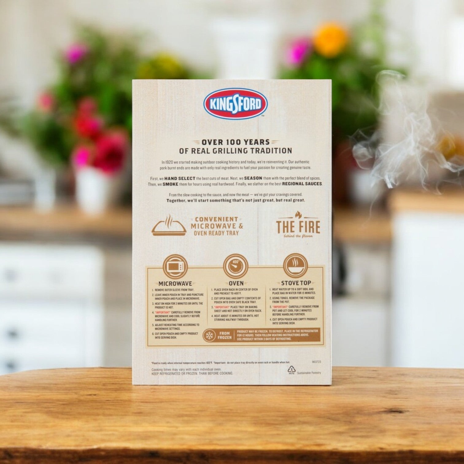 A Kingsford Pork Burnt Ends – Seasoned & Seared, 16 oz.-3 Count package is displayed on a kitchen counter, showing microwave, oven, and stovetop instructions. The blurred kitchen backdrop enhances the promise of rich BBQ taste with a perfect smoky flavor.