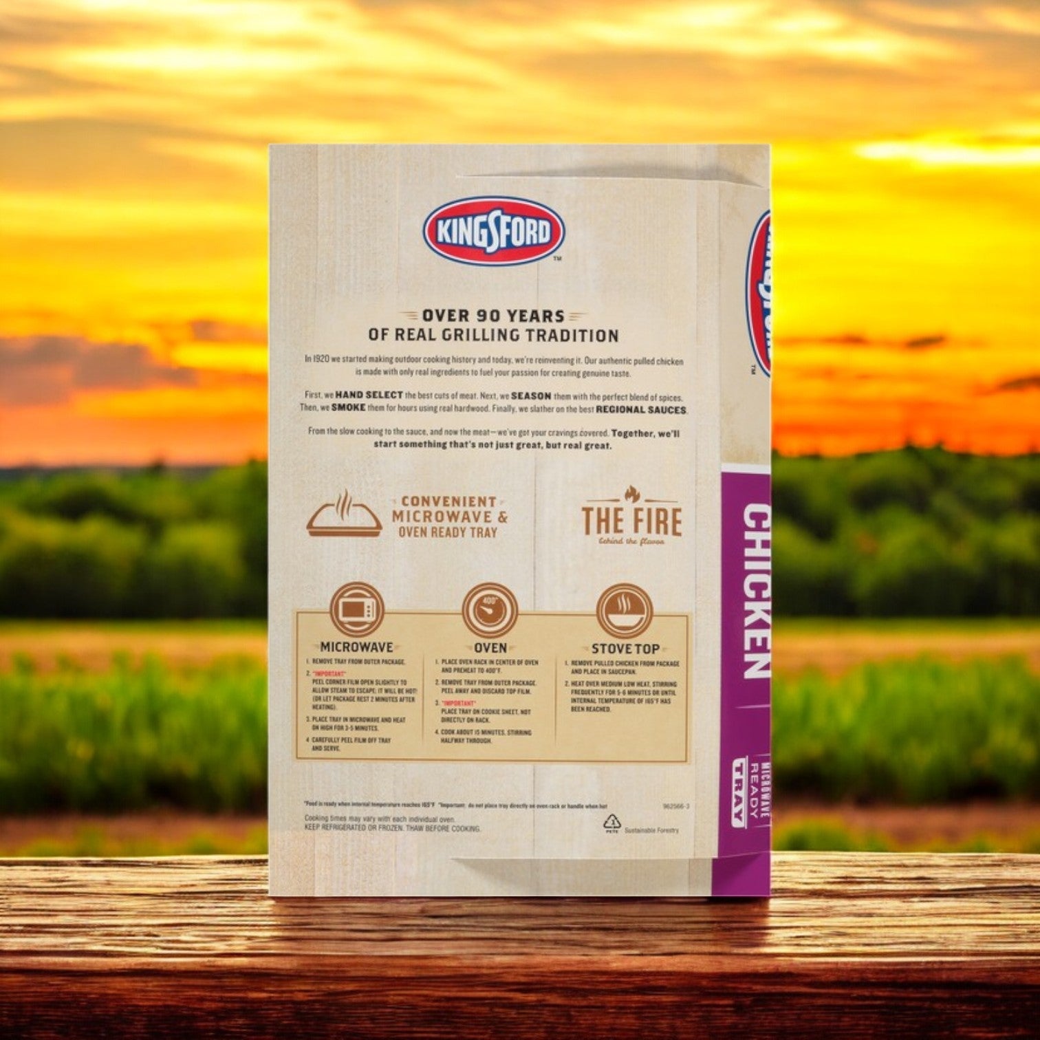 On a wooden table outdoors, the back of a Kingsford Pulled Chicken 16 oz package displays BBQ Flavor cooking instructions for microwave, oven, and stovetop methods as a sunset adds warmth to the background, setting the scene for an ideal feast.